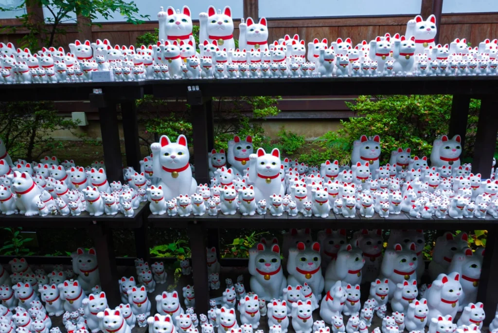 A close-up view of the famous white statues at Gotokuji lucky cat temple in Tokyo.