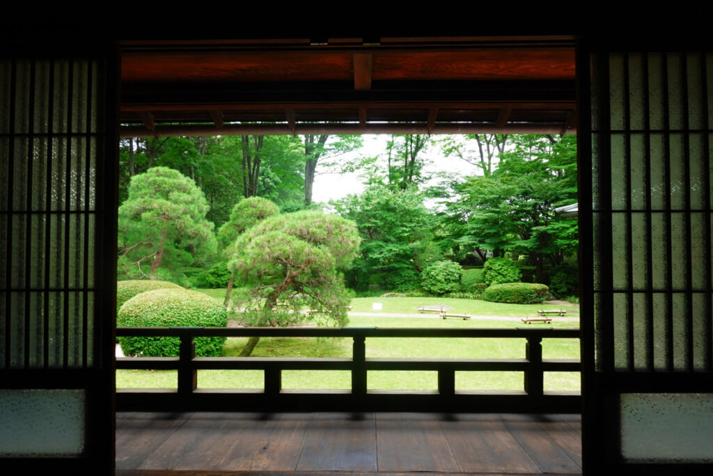 View from a veranda at the Edo-Tokyo Open Air Architectural Museum over a formal garden with sculpted pines
