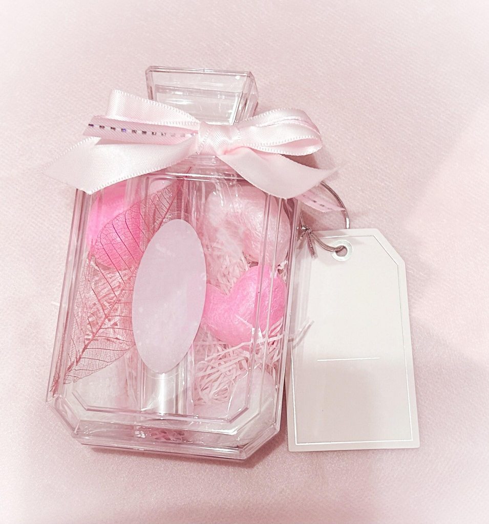 A perfume bottle shaped gift box tied with ribbon