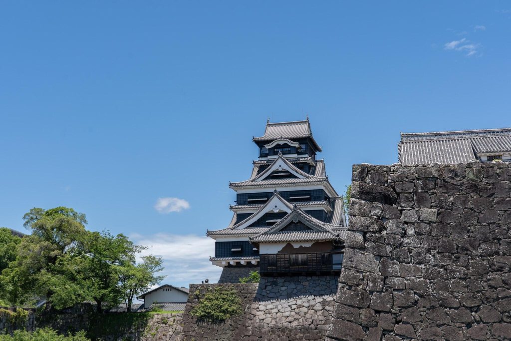 The keep of Kumamoto Castle rising above its stone walls The keep of Kumamoto Castle rising above its stone walls
