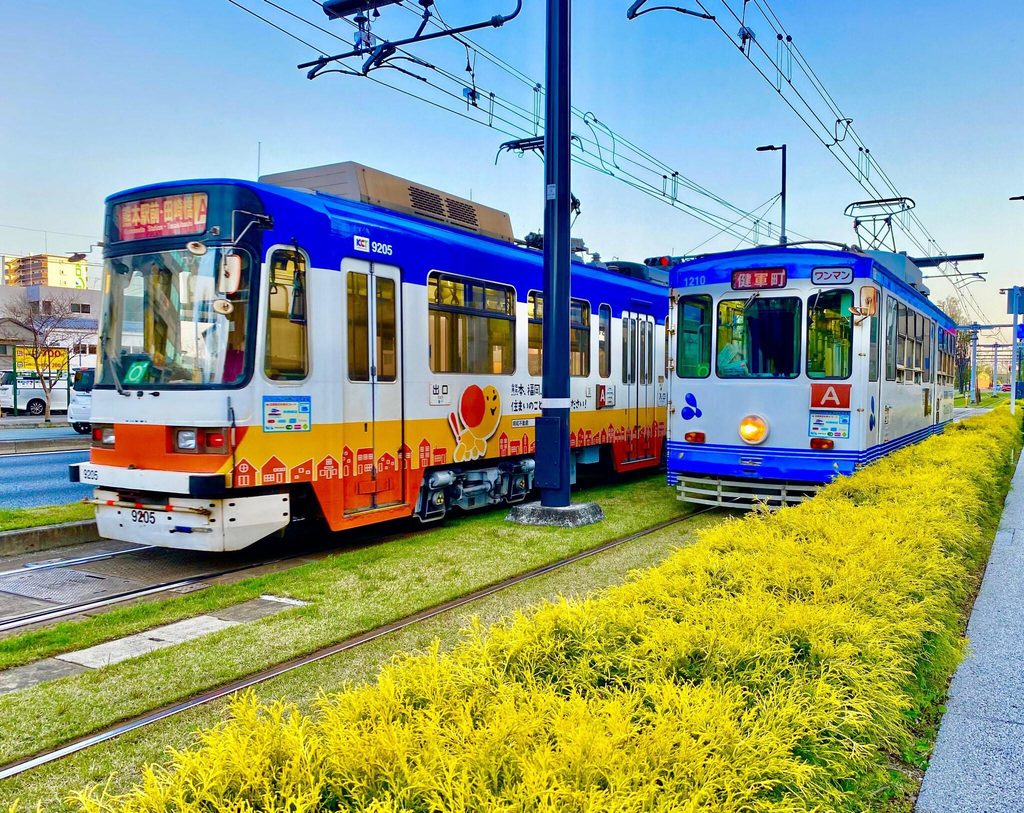 Two Kumamoto city trams, the backbone of Kumamoto travel within the city Two Kumamoto city trams, the backbone of Kumamoto travel within the city