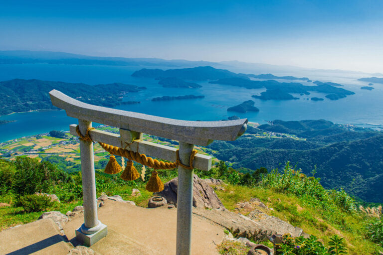 The torii of Kuratake Shrine on the summit of Mount Kuratake, high above the sea and its islands