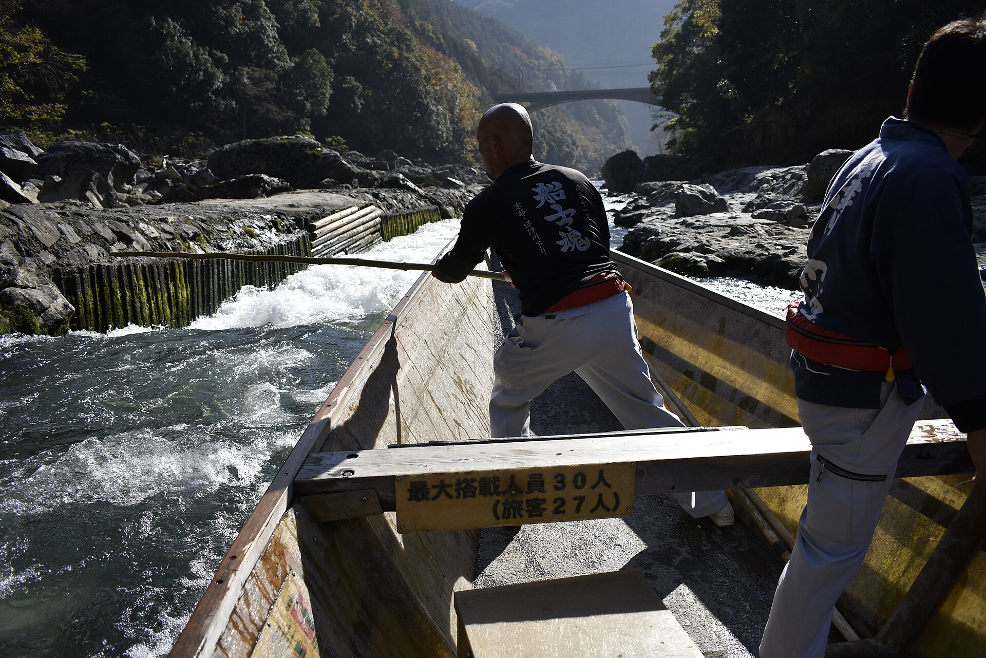 Hozugawa river boat with boatmen in the Hozu Gorge