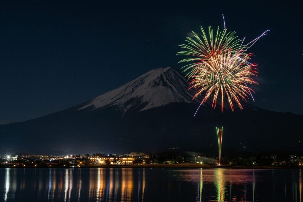 Winter fireworks over Lake Kawaguchi with snow-capped Mt Fuji