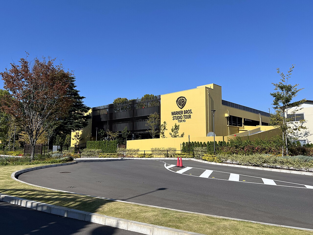 Yellow Warner Bros. Studio Tour Tokyo building exterior with WB logo, Kasugacho, Nerima