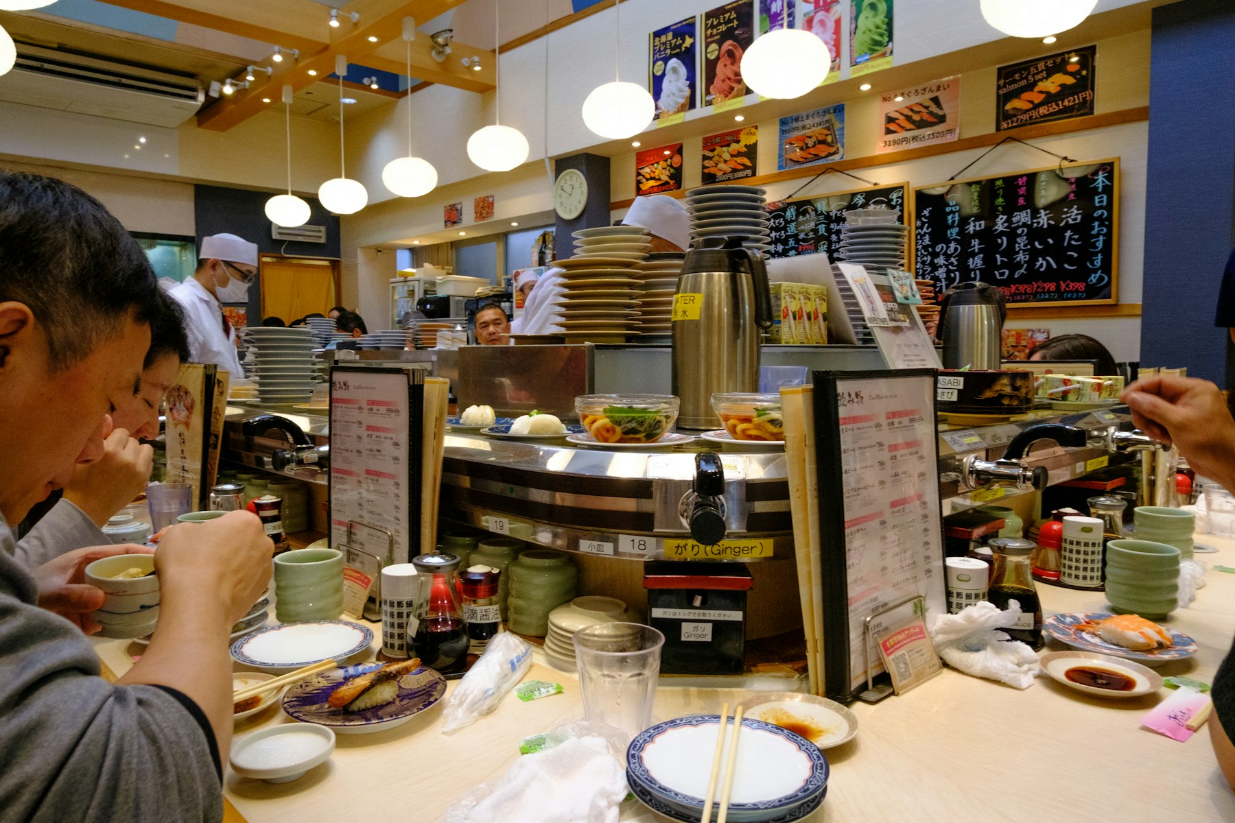 Diners at a busy sushi counter in Tsukiji, Tokyo