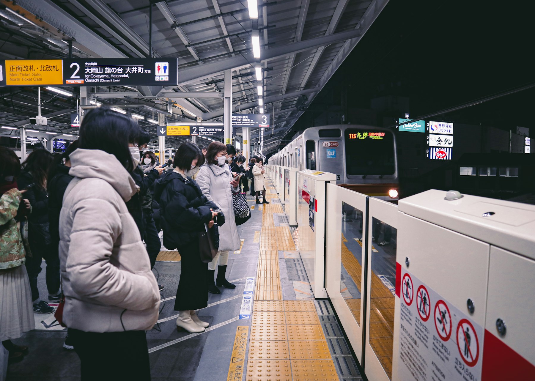 Commuters waiting on a Tokyo train platform