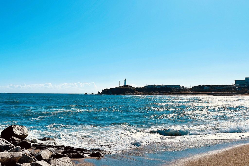 Inubosaki Lighthouse on its cape at Choshi, Chiba, seen from the beach Inubosaki Lighthouse on its cape at Choshi, Chiba, seen from the beach