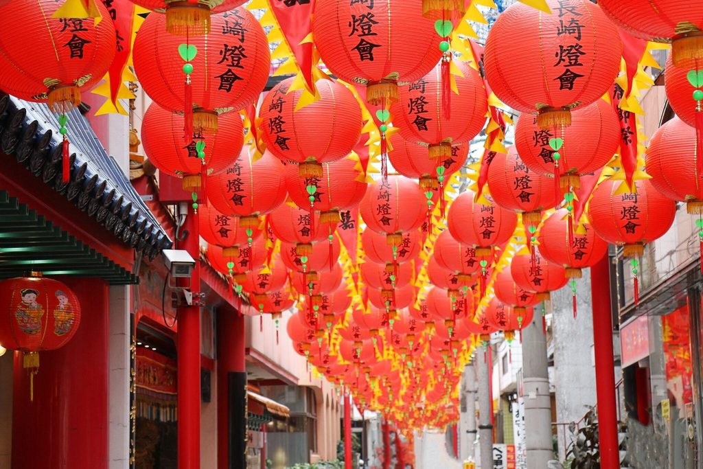 Red lanterns marked Nagasaki Lantern Festival strung over a street in Nagasaki Red lanterns marked Nagasaki Lantern Festival strung over a street in Nagasaki
