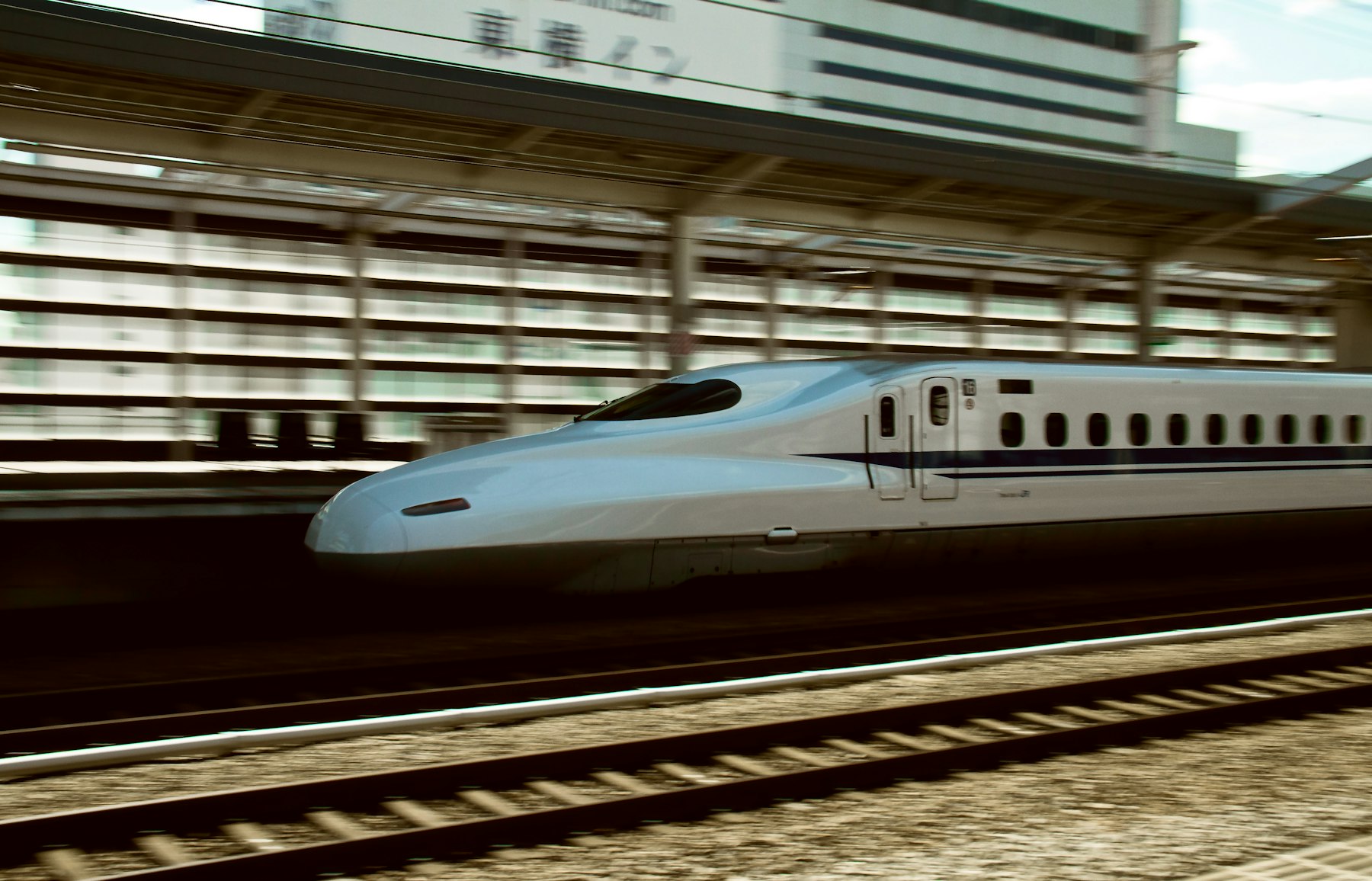 Shinkansen bullet train travelling through a Japanese city