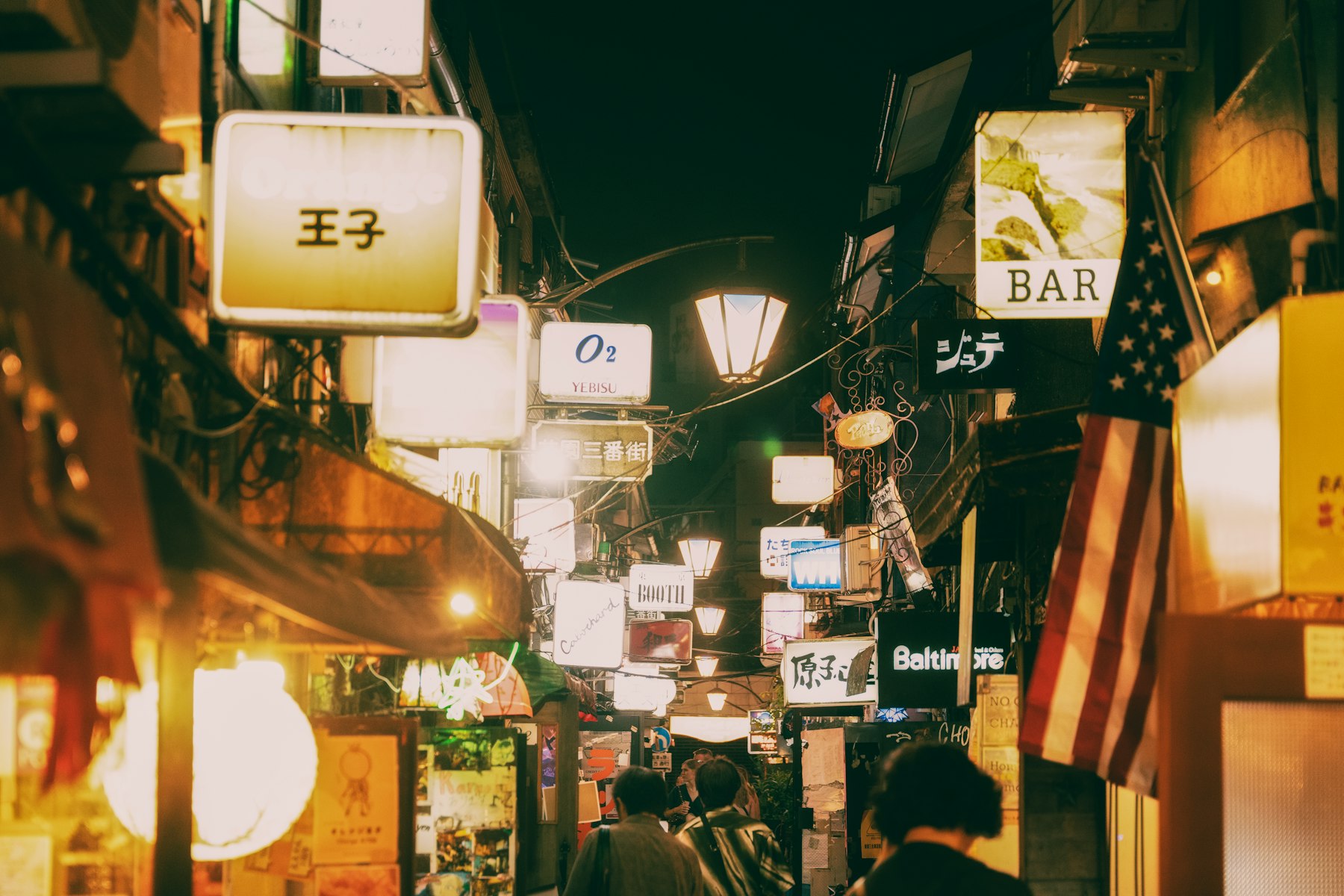 Tokyo bar alley with glowing signs at night
