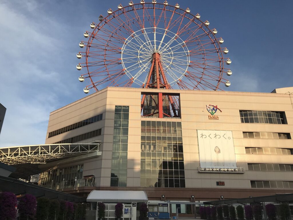 Free shinkansen tickets for tourists end here: Amu Plaza Kagoshima and its ferris wheel at Kagoshima-Chuo Station