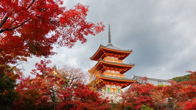 Three-storey pagoda, Kiyomizu-dera, Kyoto, Japan: red maples around the orange pagoda