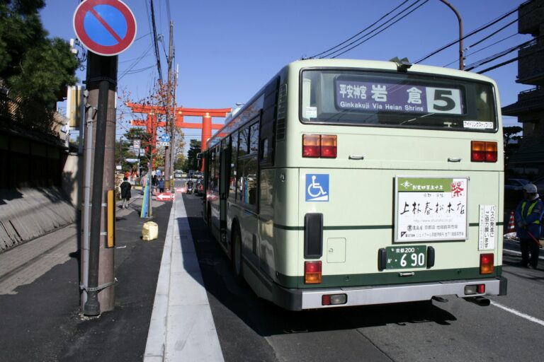 Kyoto bus November 2026: green Kyoto city bus on route 5 by the giant Heian Shrine torii, the route to Ginkakuji