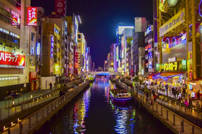 Dotonbori canal at night with neon signs and a boat, the north edge of Namba Osaka