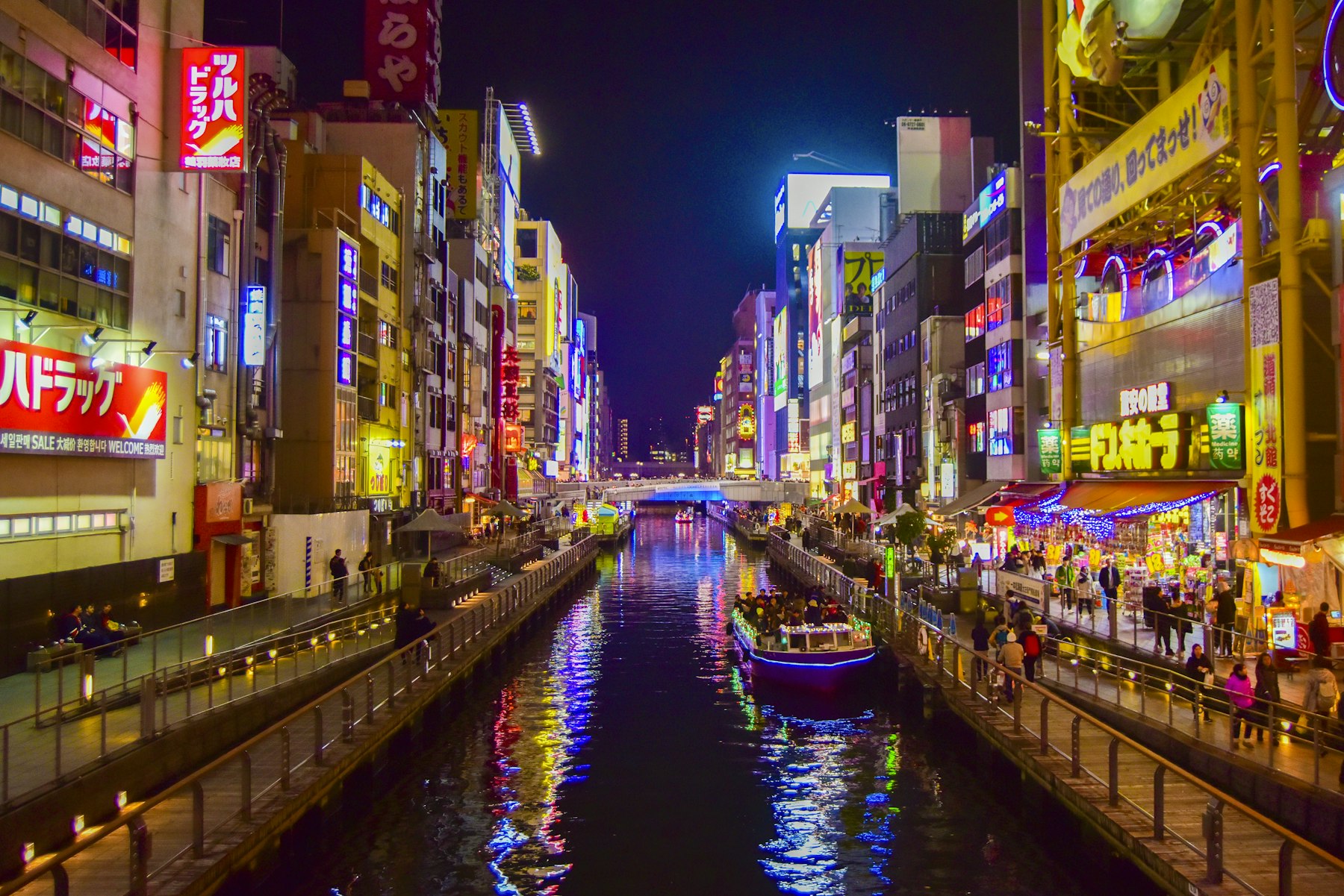 Dotonbori canal at night with neon signs and a boat, the north edge of Namba Osaka