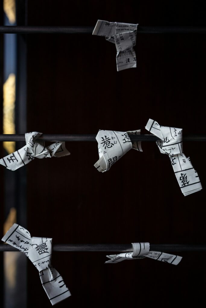 Omikuji paper fortunes tied up at a Tokyo shrine, part of hatsumode etiquette