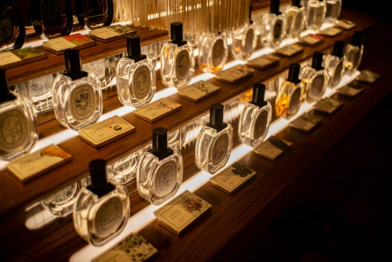 Clear glass perfume bottles on a wooden shelf