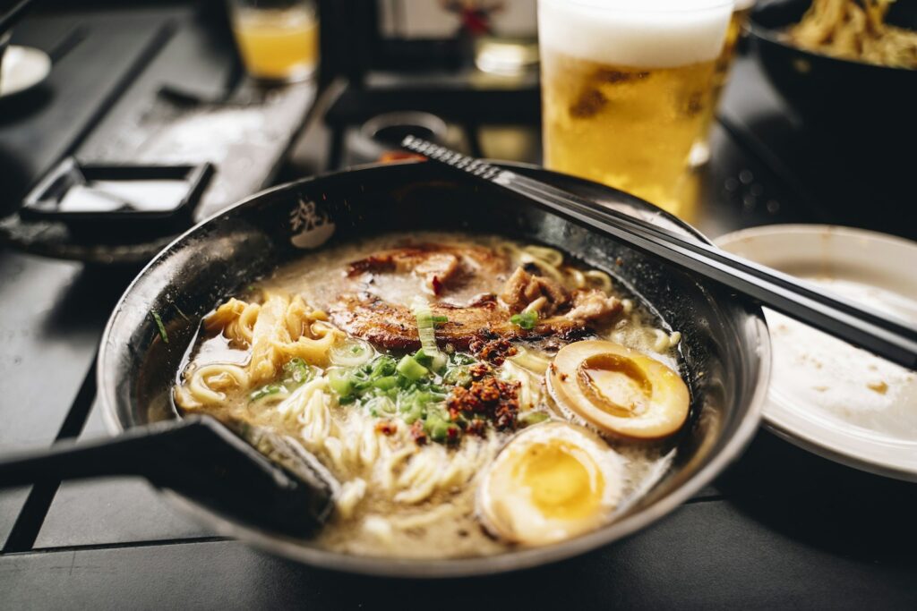 Bowl of ramen with chopsticks and a glass of beer, the kind of hot meal to have in Sapporo in February
