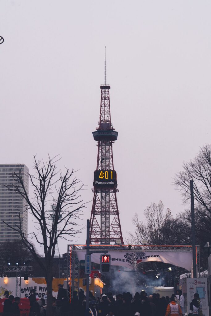 Sapporo TV Tower in falling snow on a winter evening, above Odori Park