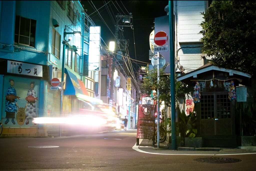Shimokitazawa, Tokyo: a quiet shopping street at night with shuttered shops and a small shrine