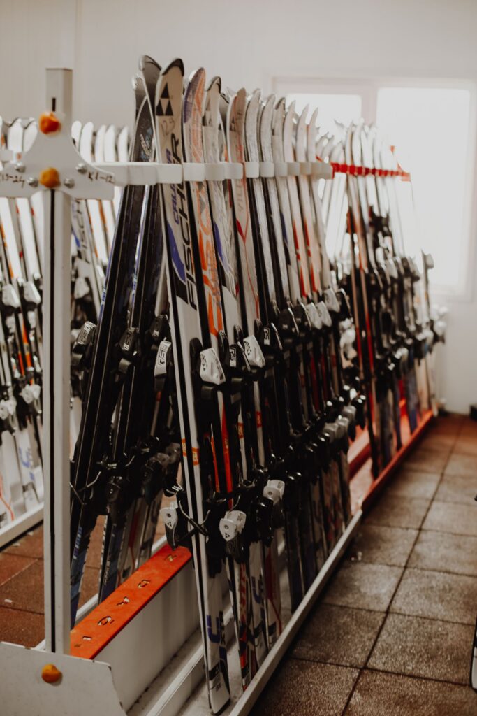 Rows of rental skis on a rack in a ski shop, ready for a ski day trip from Tokyo