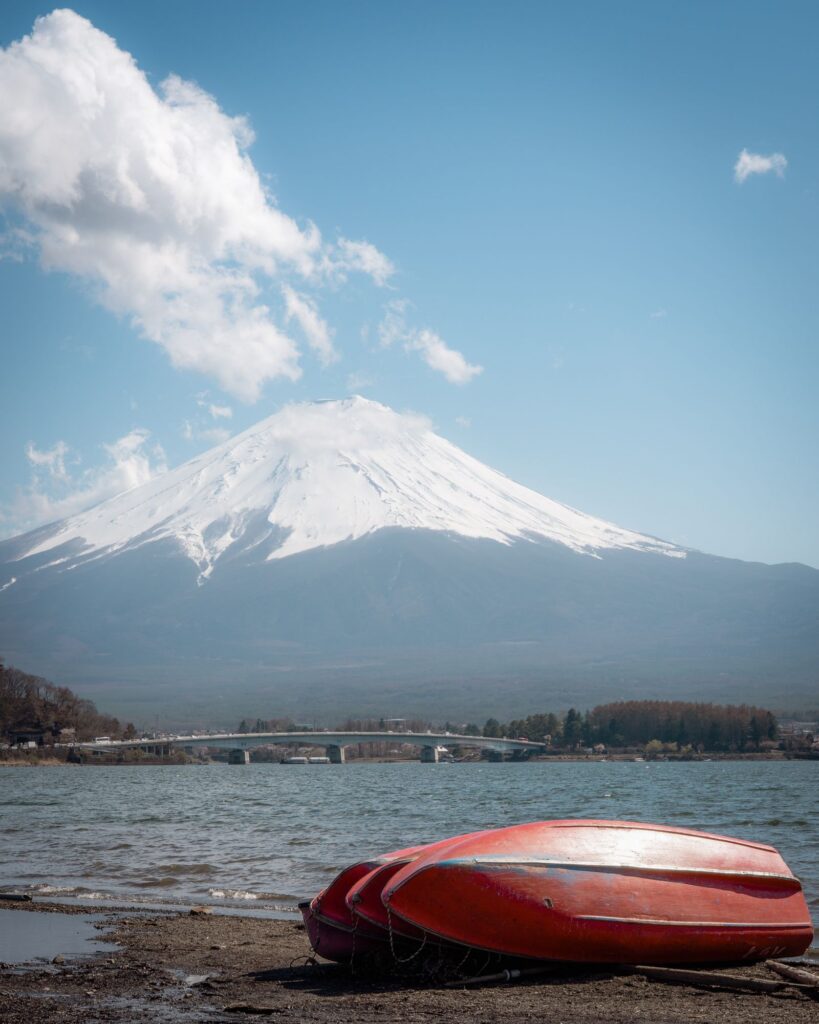 Mt Fuji over Lake Kawaguchiko with boats on the shore, a day-2 trip from the Fuji-Q Sumikko Gurashi hotel room