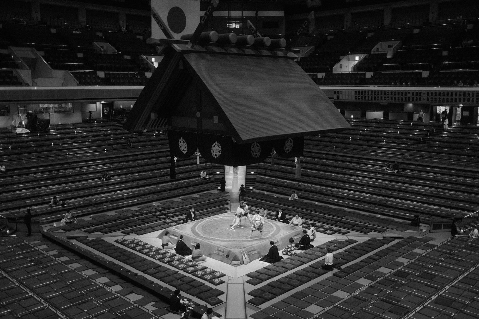 Black and white photo of a sumo wrestling match in a Tokyo arena