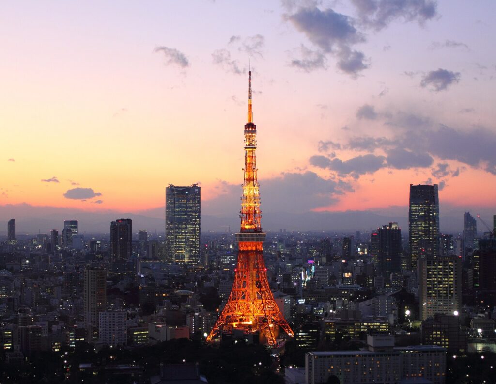Tokyo Tower lit up at sunset, a sight on the Sushi Bus Tokyo route
