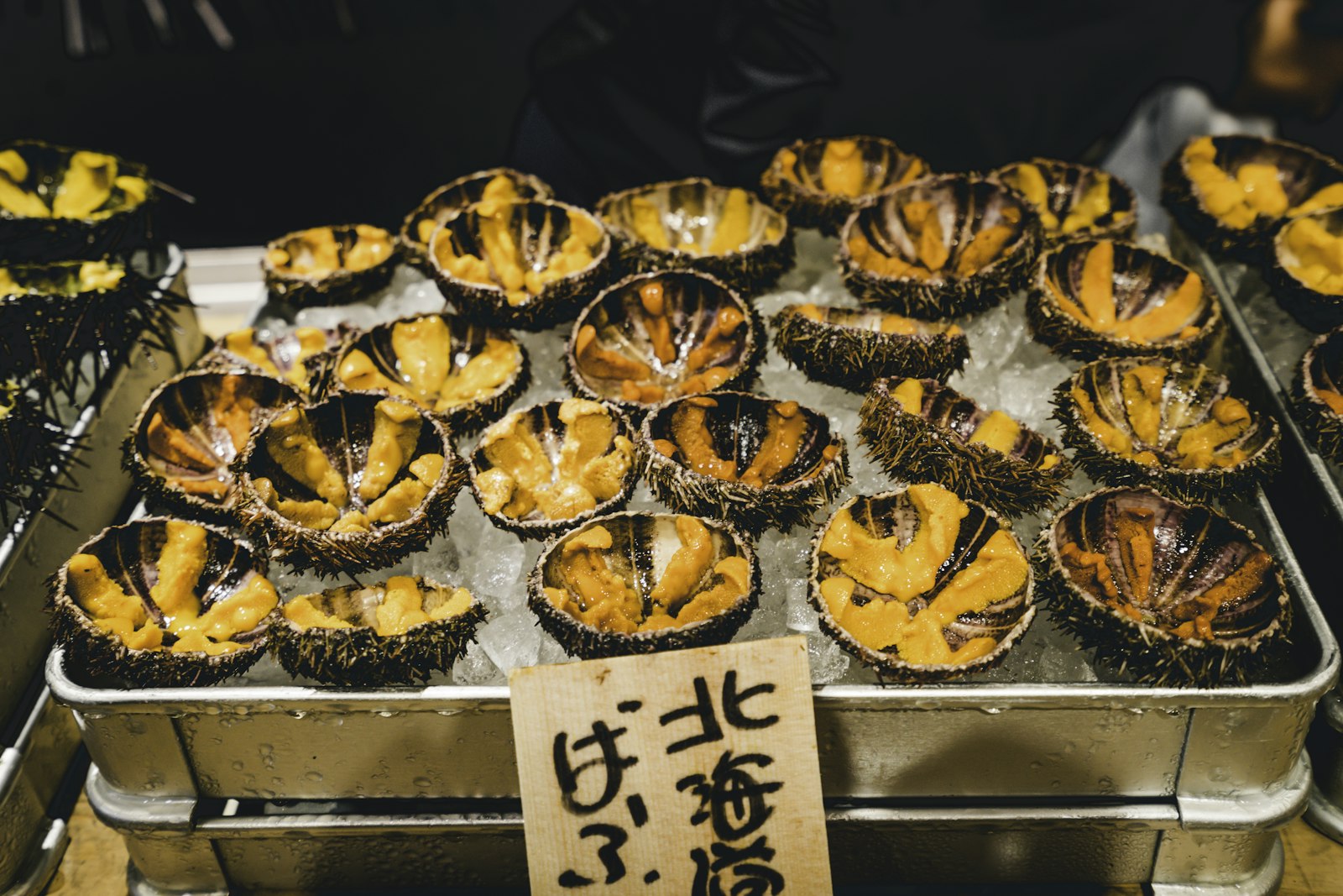 Fresh sea urchin (uni) on ice at a Tsukiji Outer Market stall